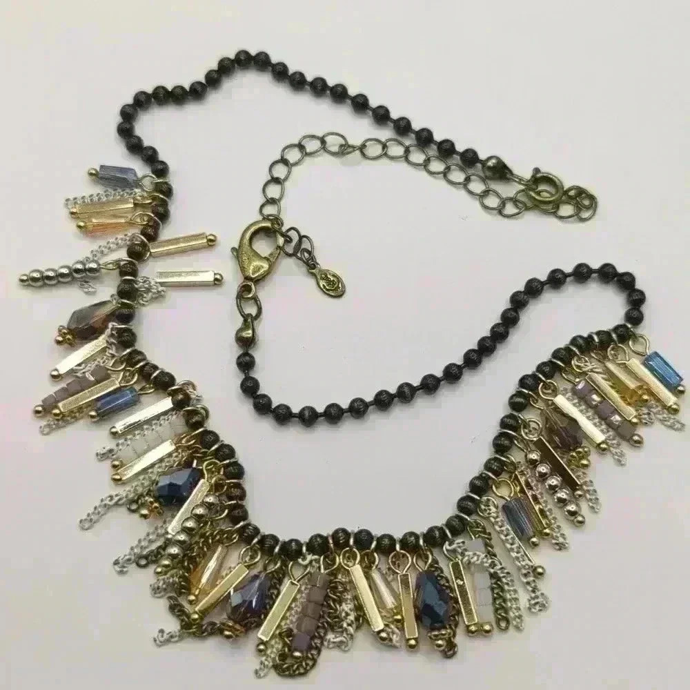 Premier Jewelry necklace with dark beads and gold, purple and white dangles.